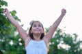 Victorious girl celebrating with her arms in the air. Achievement, success and victory concept