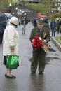 Victory Day celebration in Moscow. Senior man holds many flowers