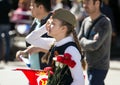 Victory Day in Moscow. Beautiful girl in military uniform with red flowers on Victory Day. Royalty Free Stock Photo