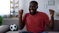 Victory of favourite football team, african-american man dancing victoriously Royalty Free Stock Photo