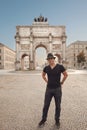 Victory Gate triumphal arch Siegestor in Munich, Germany. Tourist man in front of attraction landmark travel background. Royalty Free Stock Photo