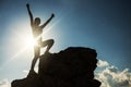 Victory hand gesture at moutain peak at sunset Royalty Free Stock Photo