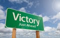 Victory Just Ahead Green Road Sign Over Clouds and Blue Sky