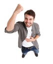 Victory is mine. High-angle shot of a happy young man in studio raising his fist in victory.