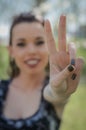 Victory Sign. Young woman doing victory sign with the hand.