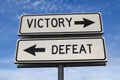 White two street signs with arrow on metal pole with word victory and defeat Royalty Free Stock Photo