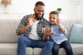 African Father And Son Using Phone Video Calling At Home Royalty Free Stock Photo