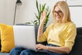 Video call concept. Happy senior woman using laptop computer for video connection from home, mature female looks at Royalty Free Stock Photo