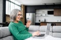Side view of lovely elderly woman chatting at the laptop Royalty Free Stock Photo