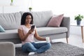 Happy young black lady have chat on mobile phone at home, talk on smartphone