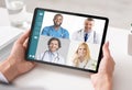 Woman With Tablet Having Consultation With Doctors Via Video Call