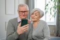 Video call. Happy senior couple woman man with smartphone having video call. Mature old grandmother grandfather talking Royalty Free Stock Photo