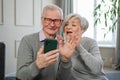 Video call. Happy senior couple woman man with smartphone having video call. Mature old grandmother grandfather talking Royalty Free Stock Photo