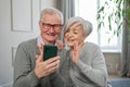 Video call. Happy senior couple woman man with smartphone having video call. Mature old grandmother grandfather talking Royalty Free Stock Photo