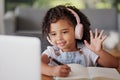 Video call, laptop and education child wave hello in online class communication, conversation or talk while at home. E Royalty Free Stock Photo