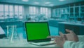 Video Call on Laptop with Green Screen on Research Biochemistry lab Desk. Advertising area, workspace mock up. Royalty Free Stock Photo