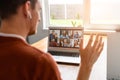 A guy is using laptop for video call, zoom