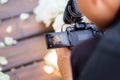 Camera in hands operator at wedding close-up Royalty Free Stock Photo