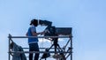 Video camera operator - man working and filming on set with his equipment Royalty Free Stock Photo