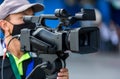 Video camera operator working with his equipment. video cinema production. Covering an event with a video camera. Professional vid Royalty Free Stock Photo