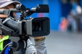 Video camera operator working with his equipment. video cinema production. Covering an event with a video camera. Professional vid Royalty Free Stock Photo