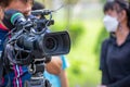 Video camera operator working with his equipment. video cinema production. Covering an event with a video camera. Professional vid Royalty Free Stock Photo