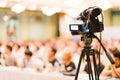 Video camera set record audience in conference hall seminar event. Company meeting, exhibition convention center concept Royalty Free Stock Photo