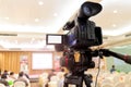 Video camera set record audience in conference hall seminar event. Company meeting, exhibition convention center, corporate Royalty Free Stock Photo