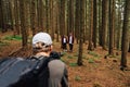 Video cameraman with a camera on a stabilizer in his hands shoots a beautiful young couple man and woman in red shirts walking