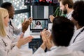 Video conference, telemedicine. Multiethnical medical scientific team applauding during a video conference or call with