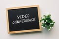 VIDEO CONFERENCE text in white chalk handwriting on a blackboard Royalty Free Stock Photo