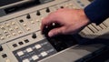 Video editing console. Media. Close-up of man using old video mixer. Man presses buttons and lever of old mounting