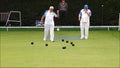 Senior members oap pensioners playing bowls bowling green outdoors active sports