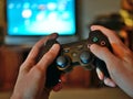 Video game console controller for gaming held in gamers hands.