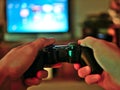 Video game console controller for gaming held in gamers hands. Royalty Free Stock Photo