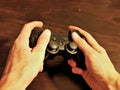 Video game console controller for gaming held in gamers hands. Royalty Free Stock Photo