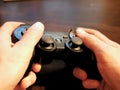 Video game console controller for gaming held in gamers hands. Royalty Free Stock Photo