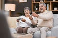 Video game, sofa and senior couple with gaming online in home for happy holiday, retirement and lifestyle together with Royalty Free Stock Photo