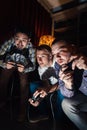 Video game tourney, young guys play with joysticks Royalty Free Stock Photo
