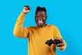 Video Gaming Concept. Euphoric African American Man With Joystick Celebrating Game Win Royalty Free Stock Photo