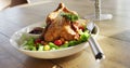 Video of healthy appetising meal with roast chicken, sauce and salad on wooden dinner table