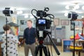 Video of the interview. Television equipment, camcorder with LCD screen, lighting equipment.