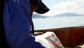 Video of local Peruvian man holding the newspaper on boat