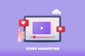 Video marketing. Video player display on tablet screen with like and heart symbol. Abstract background.