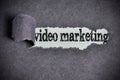 Video marketing word under torn black sugar paper Royalty Free Stock Photo