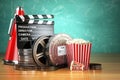 Video, movie, cinema vintage production concept. Film reels, clapperboard, tickets, popcorn and megaphone. Royalty Free Stock Photo