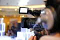 video production camera recording live event on stage. television social media broadcasting seminar conference. Royalty Free Stock Photo