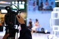 video production camera recording live event on stage. television social media broadcasting seminar conference. Royalty Free Stock Photo