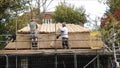 Skilled roof thatchers thatching a kent tea hut