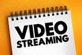 Video Streaming is a method of viewing video content without actually downloading the media files, text concept on notepad Royalty Free Stock Photo